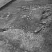 Excavation photograph : trench 1 showing walls f119 and f121 modern garden cuts and rubble f121, from SE.