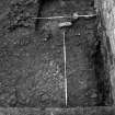 Excavation photograph : trench 2, stone spread f136 cut by trial trench.