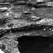 Excavation photograph : section across stone setting f280 and burnt orange soil f279, from N.