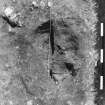 Excavation photograph. Site XI, pit K showing layer 3, from E. Half sectioned but not cleaned. Look for dark inner circle.