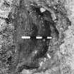 Excavation photograph. Site XI, pit J, from SW. Central post pipe removed only.