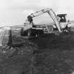 Excavation photograph. Machine clearing area of peat between sites.