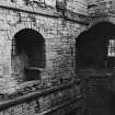 Excavation archive: Interior of tower at second floor level, showing remains of mural chamber in SE corner and window embrasure in E wall. From NW.