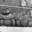 Excavation photograph : inside face of east wall of gatehouse, from south.