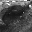 Excavation photograph : area 3 - f3020A, showing charcoal up to stone lining, grey ash deposit and red burnt sand, from N.
