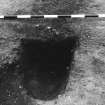 Excavation photograph : area 4A - f4126, charcoal in bottom of post pipe, from S.