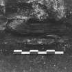 Excavation photograph : area F - preserved timber in wall 26, E part of entrance chamber.