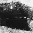 Excavation photograph : area J - detail of trial excavation at junction of two S walls in CO's stable yard, paving in base.