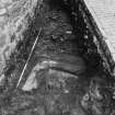Excavation photograph : area L - angled concrete gutter butted by mortared rubble 804.