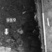 Excavation photograph : area N - slot cut through 988 with posthole 990 in base, from above.
