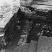 Excavation photograph : area K - further excavation of stables yard cobbles 743 with pipe trenches 725 and 744.