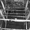 Excavation photograph: area X - hearth in NW corner of trench and rectangular stone.