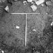 Excavation photograph: area X/H - E side of trench - remains of cobbles lying over bedrock, from above.