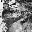 Excavation photograph : area T - showing build up of deposits on the inner face of the wall and relationship with bedrock.