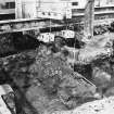 Excavation photograph: area H/X - E-W wall of Storekeepers House and N-S wall appearing.