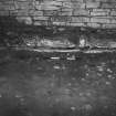 Excavation photograph :  stone plinth F02, partially exposed, from E.