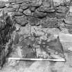 Excavation photograph - fireplace 21 partially excavated in Room II