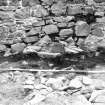 Excavation photograph - Detail of founds of 12 Room V from E