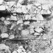 Excavation photograph - Room VI detail of fireback of 34 from E