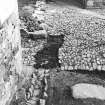 Excavation photograph : trench 2 showing cobbles being lifted.