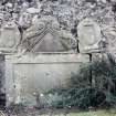 Detail of headstone and stone fragments.