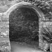 View of stone archway to kitchen garden.