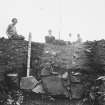Earn's Heugh, forts and settlement.
Excavation photograph showing revetment of inner bank in section 1.
Dr Margaret E C Stewart is in the photograph.