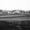 Copy of historic photograph showing distant view from NW.