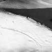 Dunnideer, fort: oblique air photograph under snow.