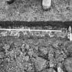 Excavation photograph - Trench I: mortar mass (Il) to the W of slabs of Ik - from N