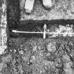 Excavation photograph - Trench I: mortar mass and recumbent grave marker (Im) - from N