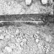 Excavation photograph - Trench I: mortar mass and recumbent grave marker (Im) - from N
