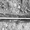 Excavation photograph - Vertical shot of conduit over the mortared rubble