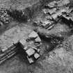 Excavation photograph showing the buttress of wall of second century granary or stone building.