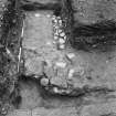 Excavation photograph of the E gate with an inverted gutter and possible foundations of the guard chamber.