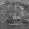 Excavation photograph : area 5 - oven base, flags and white sand, f4037, 4082, from south.