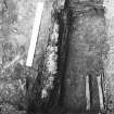 Excavation trench revealing grave