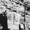 Excavation photograph. Gutter stone dressed down, Found in 1924 in disturbed area adjacent to the new villas
 in Castle Towrie field.
Copied from A O Curle photograph album MS/28/461.