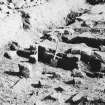 Excavation photograph. Building in praetentura looking E over tops of hypocaust 
pillars towards latrine? trench.
Copied from A O Curle photograph album MS/28/461.