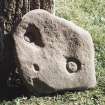 Block of stone bearing incised circular markings.