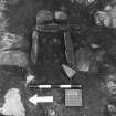 Excavation photographs: General views of site; stone surface; rectangular feature; possible hearth; drain; walls.