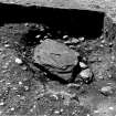 Excavation photograph : cist pit cut into natural gravel (013) and capstone (015) from north.