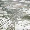 Aerial view of Muir of Ord under snow, looking NW.