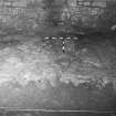 Excavation photograph : paved area (F03), partially exposed in SW corner of room, from NW.
(2 photographs overlapping, but share the same negative)