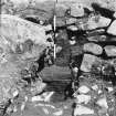 Excavation photograph : section D-E showing oak log beneath revetment wall.