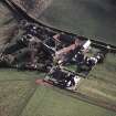 Oblique aerial view centred on the farmhouse, farmsteading, cart shed and cottages, taken from the NW.