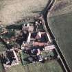 Oblique aerial view centred on the farmhouse, farmsteading, cart shed and cottages, taken from the WNW.