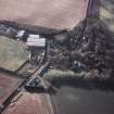 Oblique aerial view centred on the farmsteading and lodge, taken from the NE