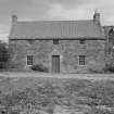 General view of cottage from west with Saltcoats Castle in the background.