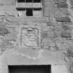 Detail of armorial plaque and window above doorway of cottage, Saltcoats Castle.